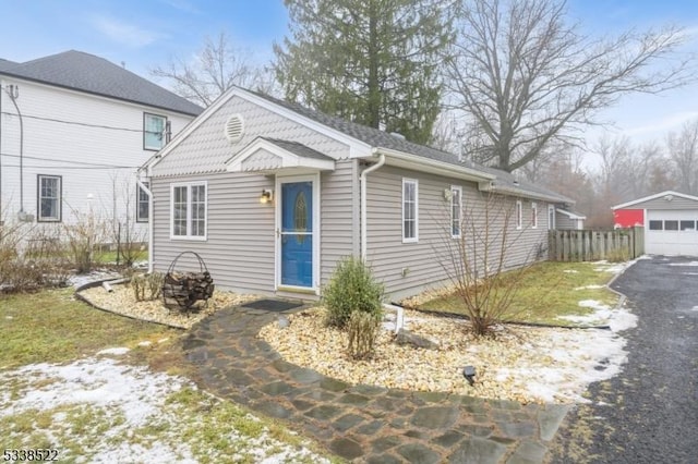 view of front of property with a garage and an outdoor structure