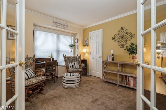 sitting room with carpet, french doors, crown molding, and baseboards