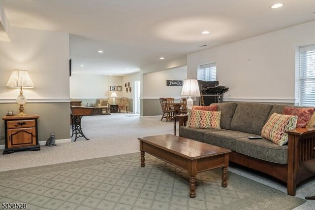 living area featuring a healthy amount of sunlight, recessed lighting, and light colored carpet