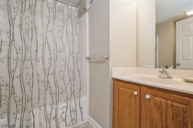 bathroom featuring shower / bath combo with shower curtain and vanity