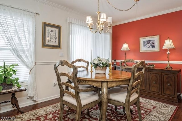 dining room featuring an inviting chandelier, baseboards, ornamental molding, and dark wood-style flooring