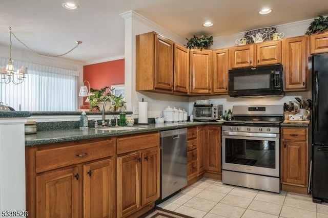 kitchen featuring brown cabinetry, dark countertops, a sink, and black appliances