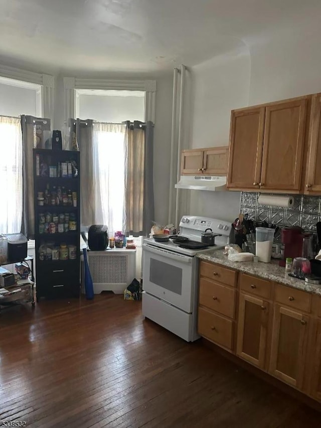 kitchen with electric stove, light stone countertops, and dark wood-type flooring