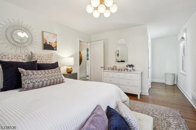 bedroom with wood-type flooring and a notable chandelier