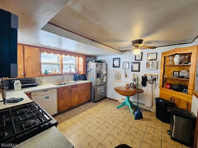 kitchen with stainless steel refrigerator with ice dispenser, sink, gas stove, white dishwasher, and ceiling fan