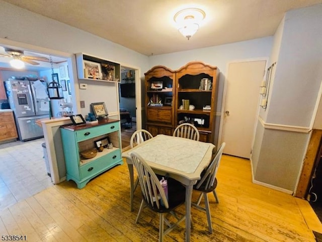 dining room featuring ceiling fan and light wood-type flooring