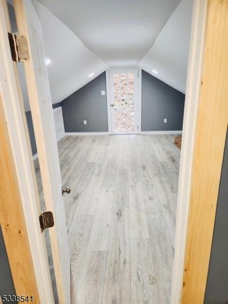 bonus room featuring lofted ceiling and hardwood / wood-style floors