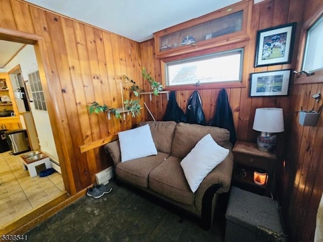 living room featuring a baseboard radiator and wood walls