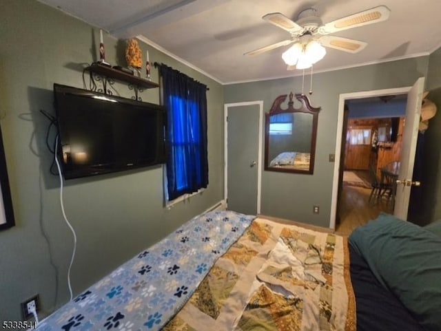 bedroom with crown molding and ceiling fan