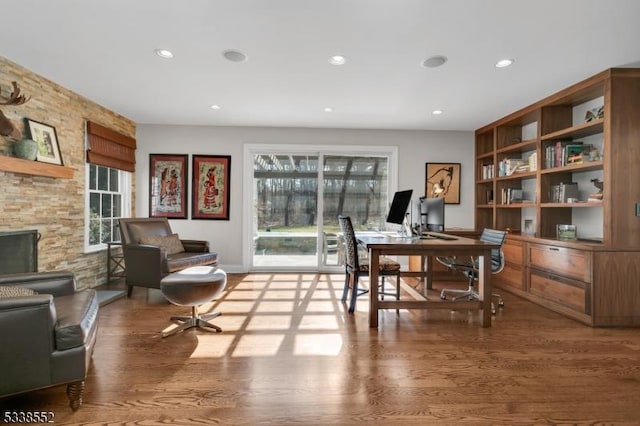 home office featuring a fireplace and wood-type flooring