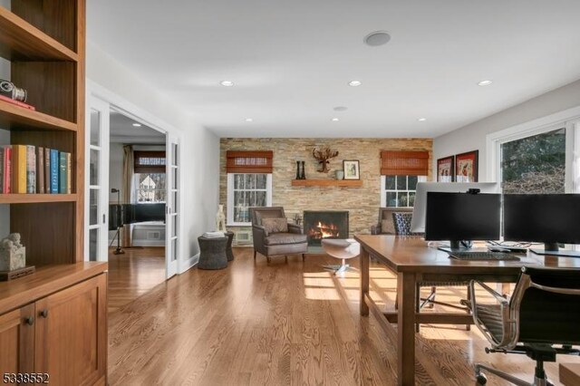 office area featuring a fireplace and hardwood / wood-style flooring