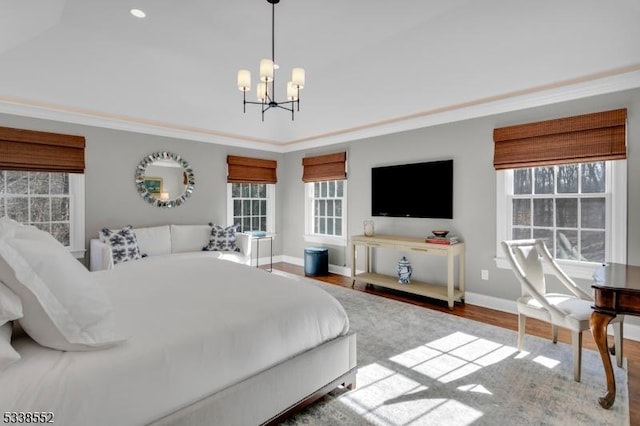 bedroom with crown molding, a chandelier, and wood-type flooring