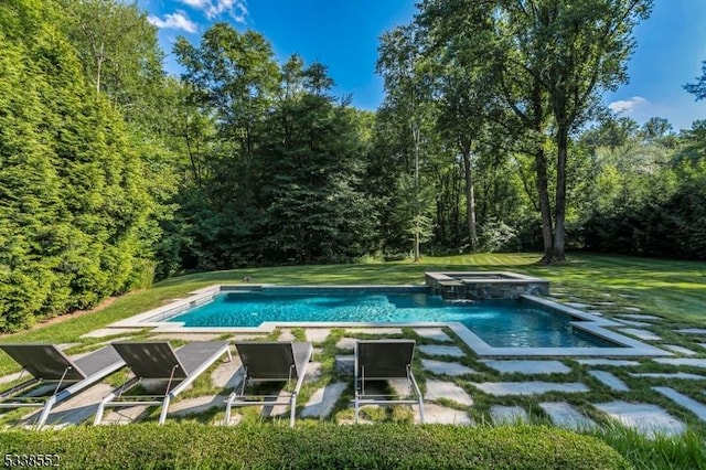 view of swimming pool featuring an in ground hot tub and a lawn