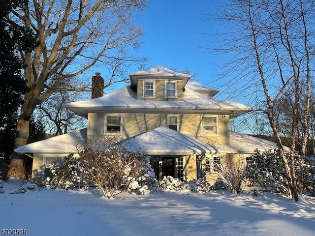 american foursquare style home featuring a chimney