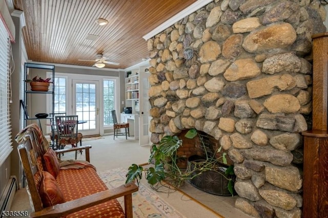 sunroom / solarium with wood ceiling, baseboard heating, a ceiling fan, and a stone fireplace