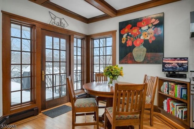 dining room with light wood-style floors, a baseboard radiator, crown molding, and beamed ceiling