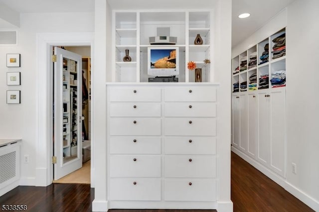 walk in closet with dark wood-style flooring and visible vents