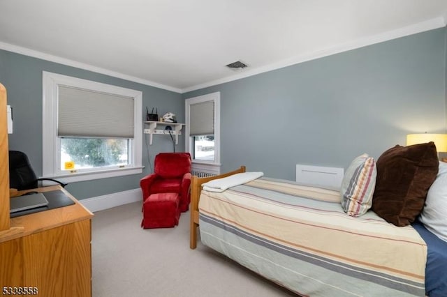 carpeted bedroom with baseboards, visible vents, and ornamental molding