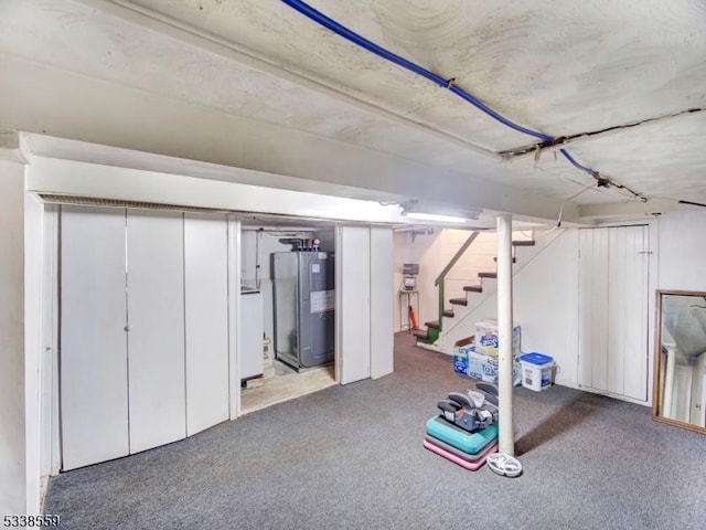 basement with washer / dryer, carpet floors, and water heater