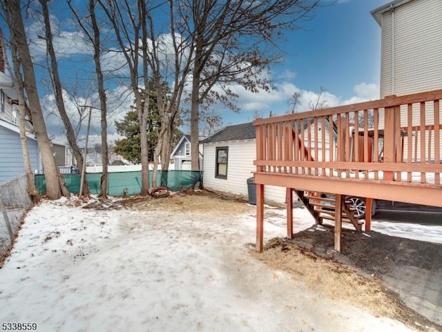 yard covered in snow featuring a deck