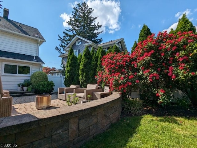 view of yard featuring a patio area, fence, and an outdoor hangout area