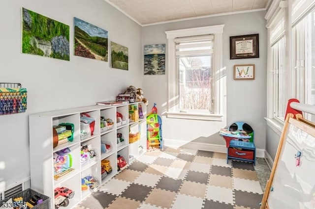 playroom with baseboards and crown molding