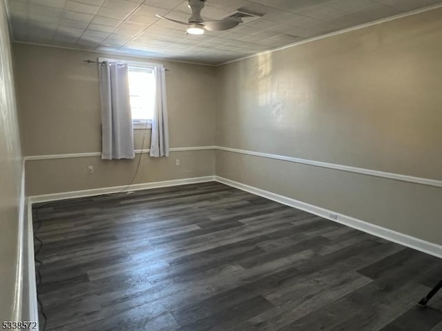 spare room with ornamental molding, dark wood-type flooring, and ceiling fan