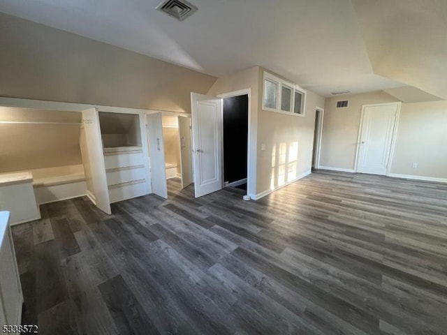 bonus room featuring vaulted ceiling and dark hardwood / wood-style floors