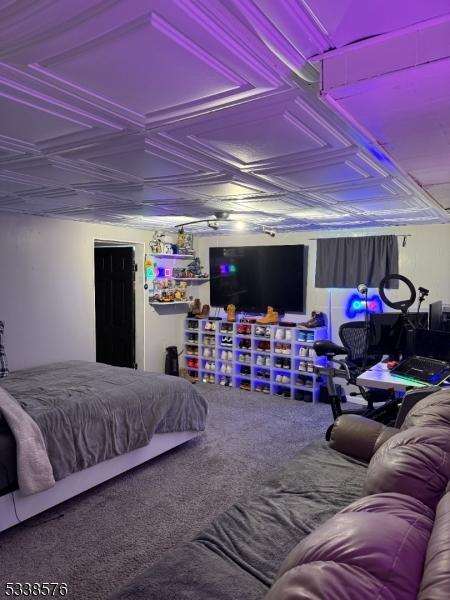 carpeted bedroom featuring an ornate ceiling