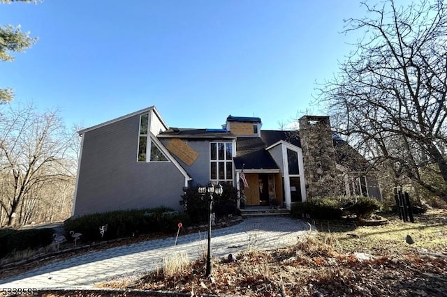 view of front of house featuring a chimney