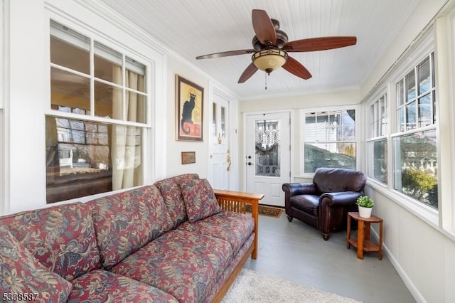 sunroom / solarium featuring a ceiling fan