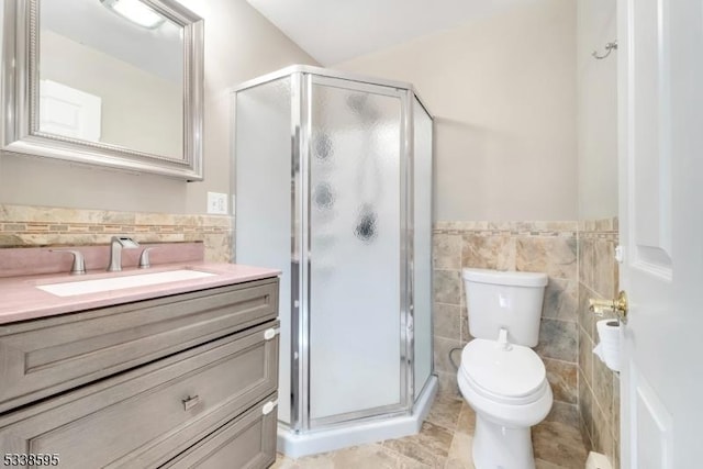 bathroom featuring tile walls, vanity, an enclosed shower, tile patterned flooring, and toilet