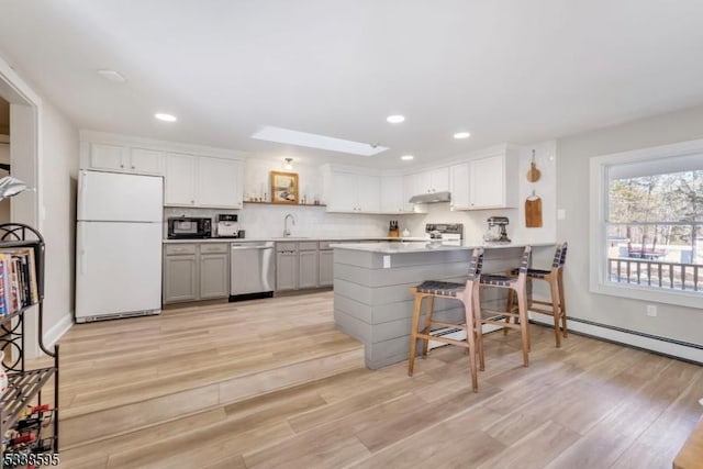 kitchen featuring white cabinetry, stove, white refrigerator, sink, and stainless steel dishwasher