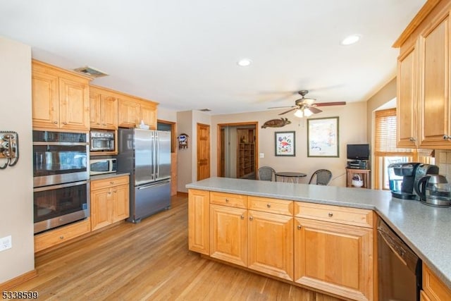 kitchen with kitchen peninsula, light brown cabinetry, ceiling fan, light hardwood / wood-style floors, and stainless steel appliances