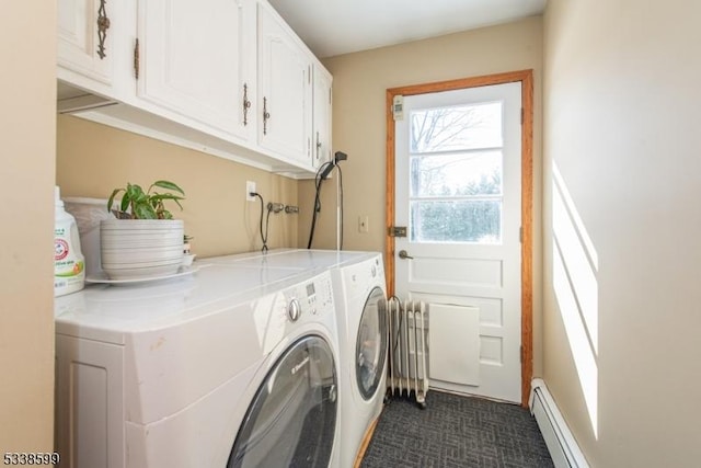 clothes washing area featuring cabinets, a baseboard heating unit, radiator, and washer and clothes dryer