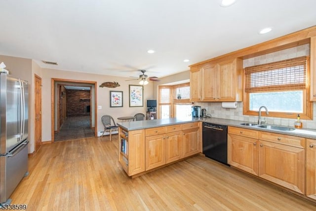 kitchen with stainless steel refrigerator, dishwasher, sink, kitchen peninsula, and light hardwood / wood-style flooring