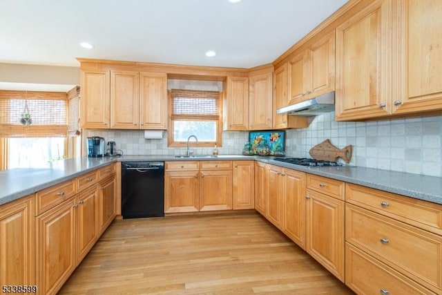 kitchen featuring stainless steel gas stovetop, black dishwasher, sink, backsplash, and light hardwood / wood-style flooring