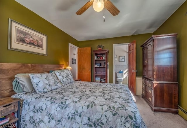 bedroom featuring connected bathroom, light colored carpet, and ceiling fan