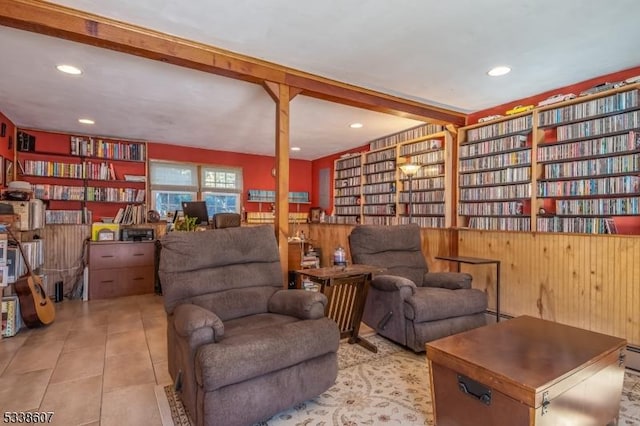 living area with light tile patterned floors, beamed ceiling, and baseboard heating