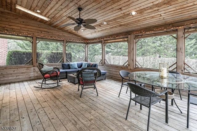 sunroom / solarium with vaulted ceiling, ceiling fan, and wood ceiling