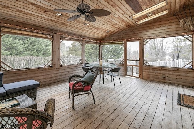 sunroom with ceiling fan, vaulted ceiling, and wooden ceiling