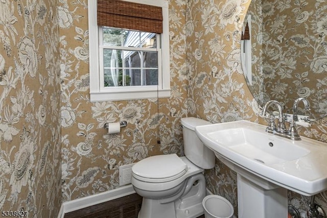 bathroom with wood-type flooring and toilet