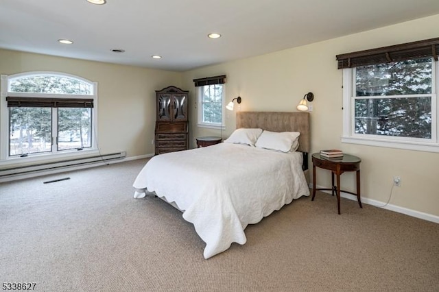 carpeted bedroom with multiple windows and a baseboard radiator