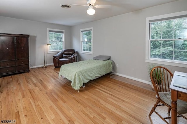 bedroom with light hardwood / wood-style flooring and ceiling fan