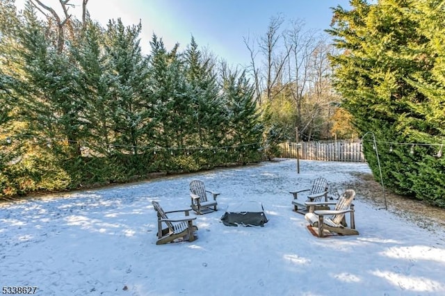 snowy yard featuring a fire pit