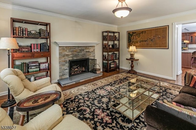 living room featuring crown molding, a stone fireplace, and wood-type flooring