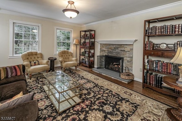 living room featuring a stone fireplace, crown molding, and wood-type flooring