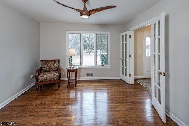 sitting room featuring dark hardwood / wood-style floors and french doors