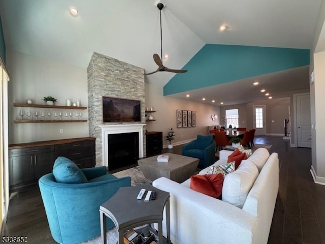 living area with high vaulted ceiling, dark wood-type flooring, a fireplace, and baseboards