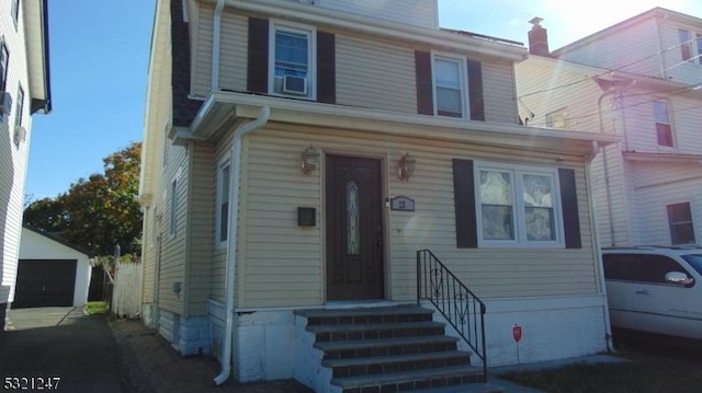 view of front of house featuring a garage and an outdoor structure